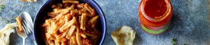 Bowl of pasta and a jar of Stefano's Pasta Sauce